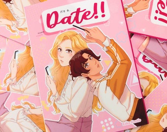 May include: A pink and white comic book cover with the title "It's a... Date!" in a large, red font. The cover features a young woman with blonde hair and a young man with brown hair. The woman is holding a phone and the man is holding a magic wand. The book is by Edea Kontio.