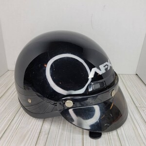 May include: A black motorcycle helmet with a visor. The helmet features the white text "AFX" on the side. The visor is made of a dark, transparent material. The helmet has a rounded shape and is designed for head protection.