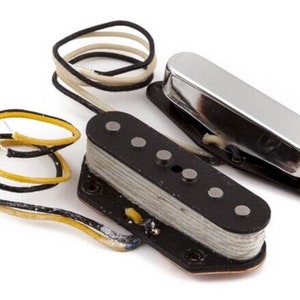 May include: Two guitar pickups, one black with six silver pole pieces and one chrome. Both pickups have wires attached.