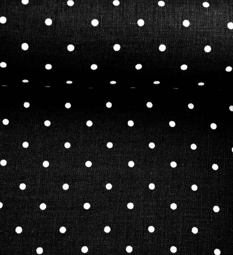 May include: Black fabric with a white polka dot pattern. The fabric is folded in half, showing the pattern on both sides.