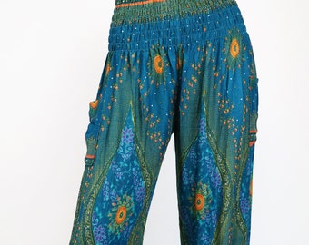 May include: Teal blue printed pants with an elastic waistband and side pockets. The pants have a floral pattern with orange, green, and purple accents.