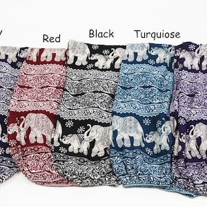 May include: Five pairs of elephant print harem pants in different colors: navy, red, black, turquoise, and purple. The pants have a wide, flowing leg and an elastic waistband.