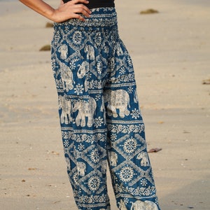 May include: A pair of blue harem pants with a white elephant print. The pants have a wide, flowing leg and a comfortable elastic waistband.