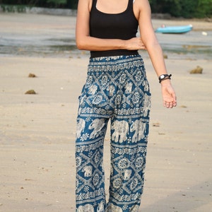 May include: Blue and white patterned pants with an elephant design. The pants are loose fitting and have a wide leg.