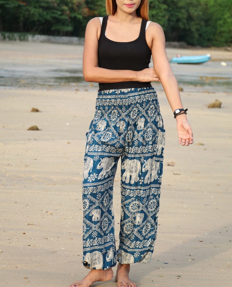 May include: Blue and white patterned pants with an elephant design. The pants are loose fitting and have a wide leg.