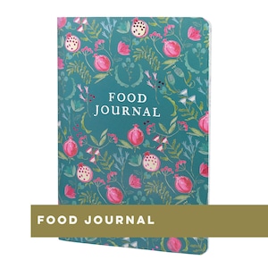 May include: A teal food journal featuring a floral design of pink pomegranates and white flowers. The words "FOOD JOURNAL" are printed in white on the cover. The journal is rectangular, with a gold band at the bottom that reads "FOOD JOURNAL".