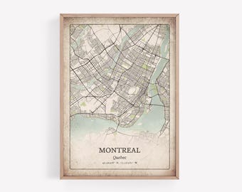 May include: A framed map print of Montreal, Quebec, with a vintage aesthetic. The map features a detailed street layout in black and white, with light green and blue accents for water and parks. The city name and coordinates are printed at the bottom.
