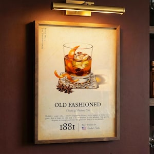 May include: A wooden-framed print depicting an Old Fashioned cocktail, with a detailed illustration of the drink with ice, orange peel, and a cherry. The print includes the text "Old Fashioned" and a recipe, with the year 1881 and a US flag.