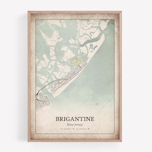 May include: A framed map print of Brigantine, New Jersey, in a vintage style. The map features a detailed illustration of the coastal area, with the town's name and coordinates at the bottom. The color palette includes shades of blue, green, and beige.