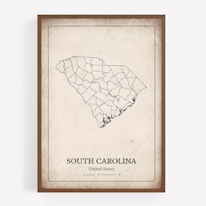 May include: A framed print featuring a vintage-style map of South Carolina, USA. The map shows county outlines and is set against a textured, off-white background. The text "SOUTH CAROLINA" and "United States" is displayed below the map.
