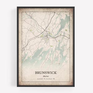 May include: A framed map print of Brunswick, Maine, featuring a vintage-style aesthetic with a beige background, black road lines, and light blue water areas. The text reads BRUNSWICK, Maine, and the coordinates 43.91461 N, 69.96401 W.