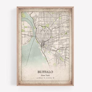 Peut inclure: Une impression encadrée d'une carte de Buffalo, New York, avec une esthétique vintage. La carte présente un plan détaillé des rues, des cours d'eau dans une teinte bleu-vert clair et des zones de parc vertes. Le nom de la ville et les coordonnées sont imprimés en bas.