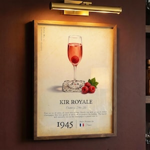 May include: A framed vintage-style print of a Kir Royale cocktail, featuring a champagne flute with a raspberry. The print includes the text "KIR ROYALE" and "1945", with a French flag. The image is set against a dark background.