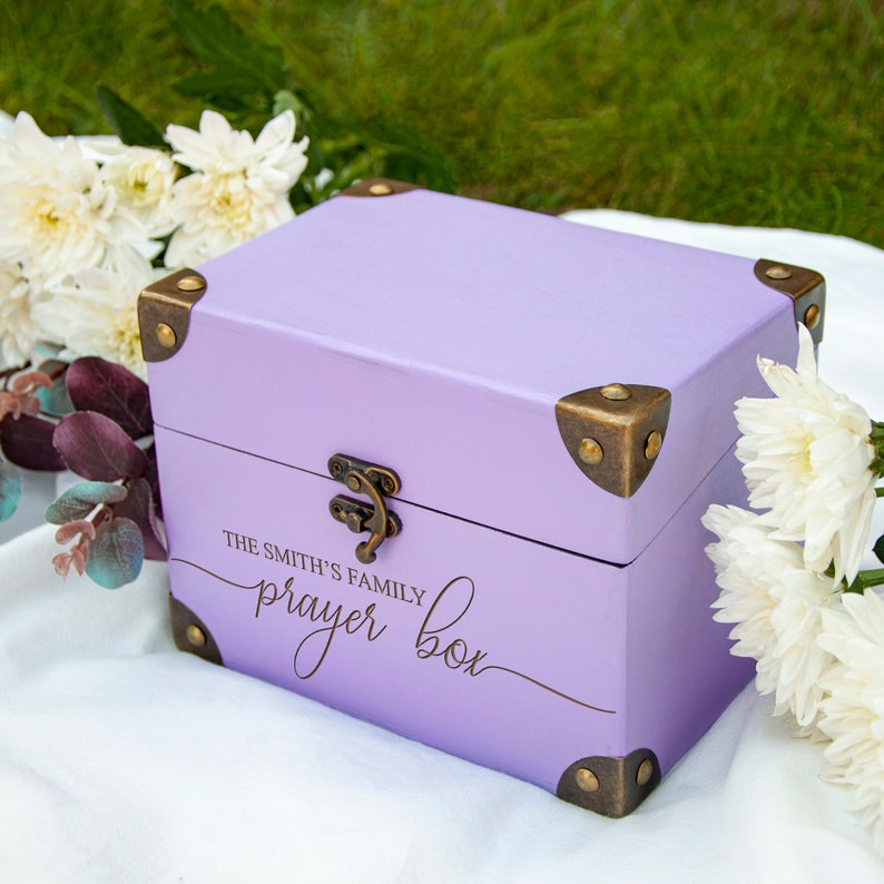 May include: A lavender wooden box with brass accents and the inscription "The Smith's Family Prayer Box".
