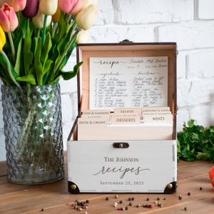 May include: A rustic wooden sign with the text "Welcome to our home" in white lettering. The sign has a distressed finish and a simple, inviting design, ideal for front door decor.