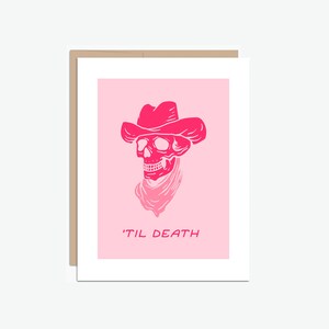 May include: Pink and white illustration of a skull wearing a cowboy hat with the text 'Til Death' underneath.