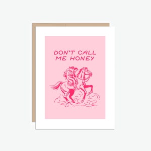 May include: Pink greeting card with the text "Don't call me honey" in a pink font. A pink illustration of a cowboy riding a horse is below the text.