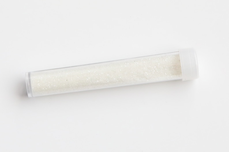 May include: A clear plastic tube filled with white glitter.