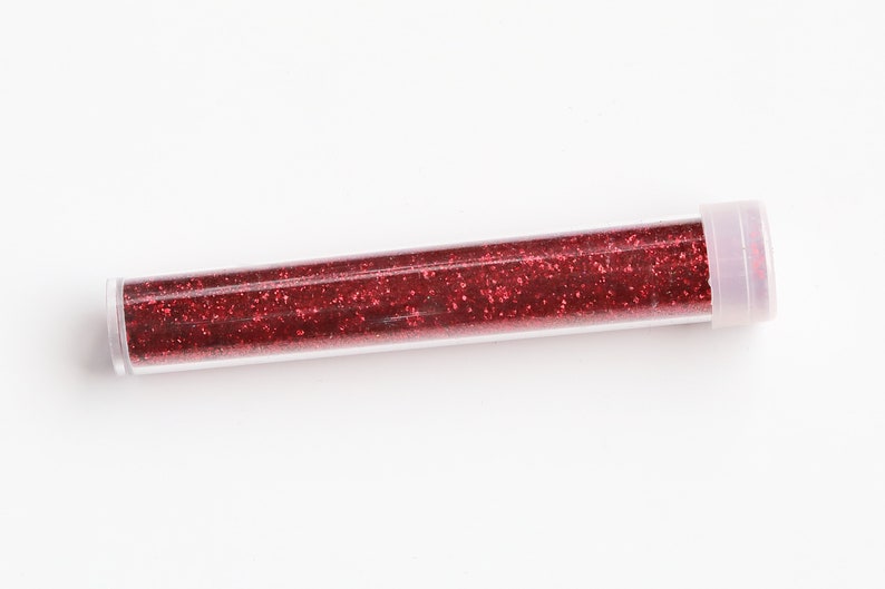 May include: A clear plastic tube filled with red glitter.