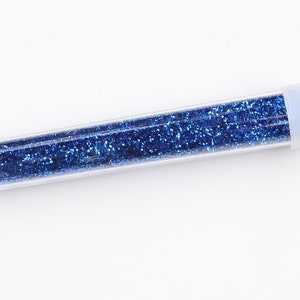 May include: A clear plastic tube filled with blue glitter.