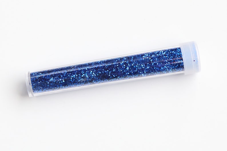 May include: A clear plastic tube filled with blue glitter.