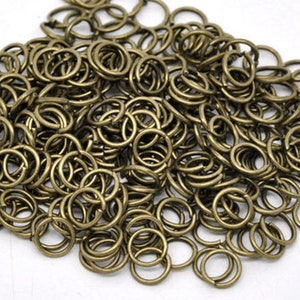 Anelli aperti da 7 mm / Bronzo antico / Calibro 18 / Spessore 1 mm / Diametro interno circa 5 mm / Confezione da 50