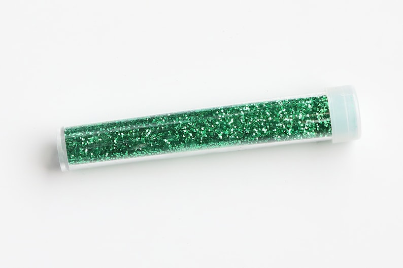 May include: A clear plastic tube filled with green glitter.