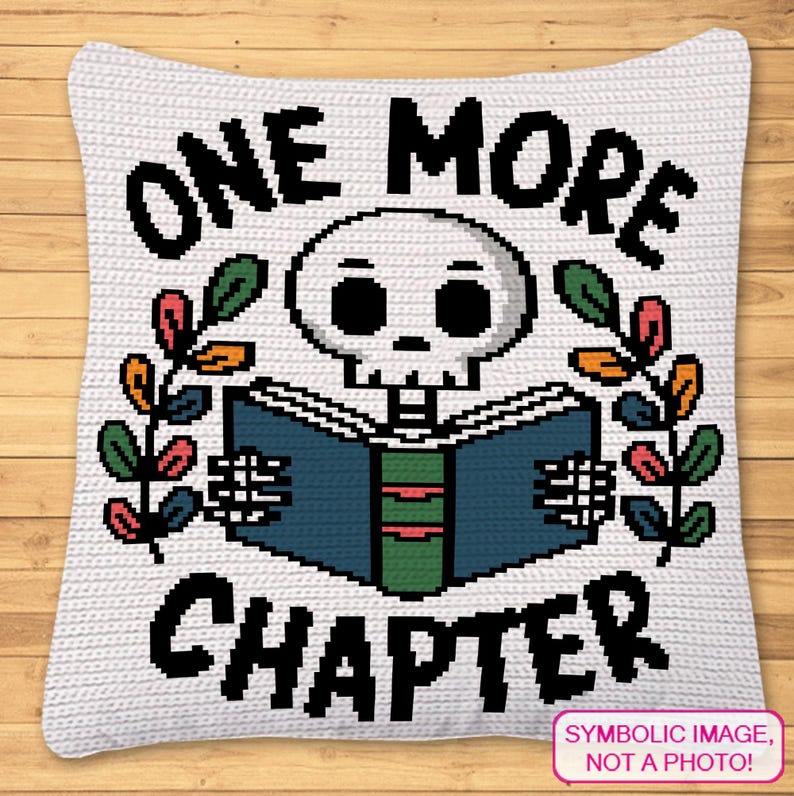May include: A white square crochet pillow featuring a pixel art design of a skull reading a blue book with a green spine. The text ONE MORE CHAPTER is printed in black pixelated font above and below the skull, flanked by colorful leaves.
