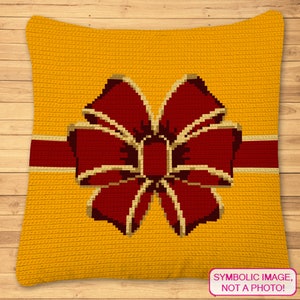 May include: A yellow crocheted pillow with a red bow and a gold ribbon. The pillow has a textured surface and the text "SYMBOLIC IMAGE, NOT A PHOTO!" is printed on the bottom right corner.