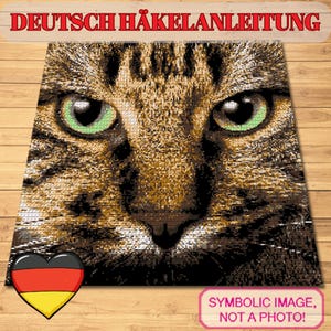 May include: A square, pixelated image of a cat's face with green eyes and brown and black fur. The text "DEUTSCH HÄKELANLEITUNG" is at the top. A heart with the German flag is in the lower left corner, and the text "SYMBOLIC IMAGE, NOT A PHOTO!" is in the lower right.