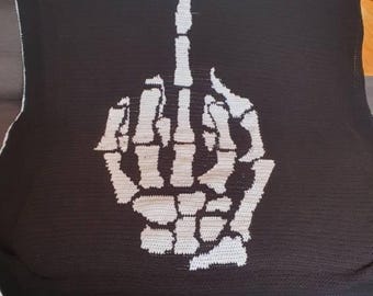 May include: A black and white crocheted throw blanket with a skeleton hand giving the middle finger.