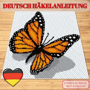 May include: A pixelated monarch butterfly with orange and black wings is centered on a white background. The text "DEUTSCH HÄKELANLEITUNG" is at the top. A heart with the German flag is in the lower left corner. The text "SYMBOLIC IMAGE, NOT A PHOTO!" is in the lower right.