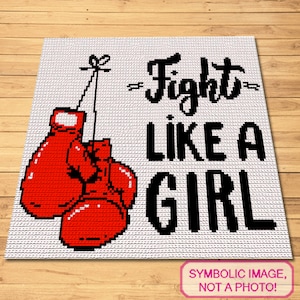 May include: A white crochet square with the text "Fight Like A Girl" in black lettering. Two red boxing gloves are hanging from the top of the square.