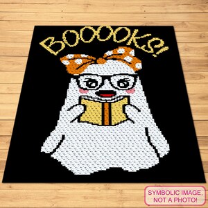 May include: A black square rug with a pixelated ghost reading a book. The ghost wears glasses and a bow with orange polka dots. The word "BOOOOKS!" is written above the ghost in yellow.