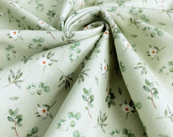 Jersey de algodão | Tecido de malha de algodão | Jersey simples ecológico | Estampa infantil: Flores brancas em verde