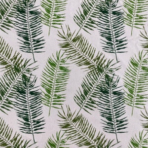 May include: A seamless pattern of green palm leaves on a white background. The leaves are arranged in a random pattern, creating a tropical feel.