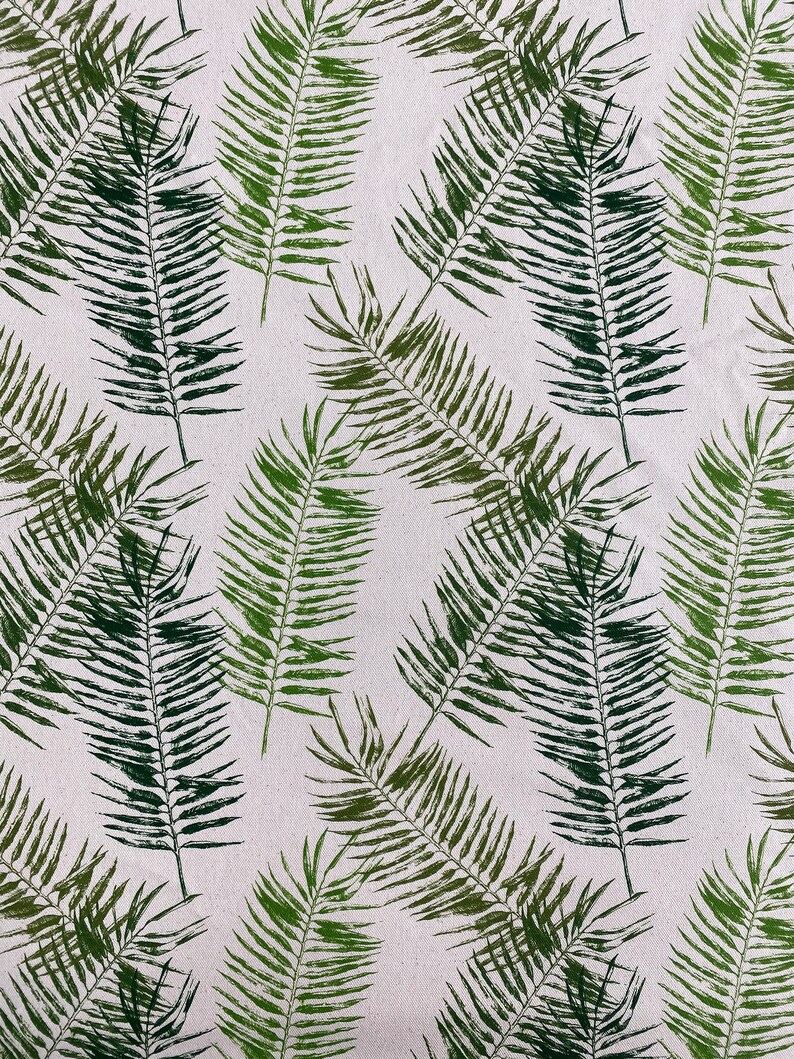 May include: A seamless pattern of green palm leaves on a white background. The leaves are arranged in a random pattern, creating a tropical feel.