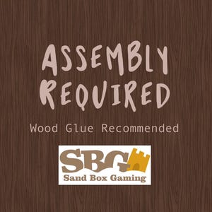 Może przedstawiać: Drewniany zestaw do samodzielnego montażu z napisem "Assembly Required" i "Wood Glue Recommended". Zestaw pochodzi od Sand Box Gaming, firmy produkującej drewniane zestawy do samodzielnego montażu.