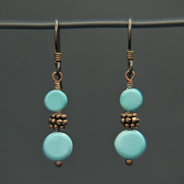 Eye-catching Turquoise set off by Copper in earring in the showy South Western way, dangling from a Mixed Color Hook Earwire