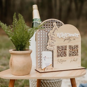 May include: Wooden sign with a woven pattern, the text "Let's get social! Wildflower party co." and two QR codes labeled "Instagram" and "Website".