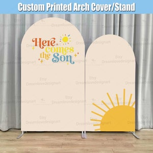 May include: A custom printed arch cover with a peach background and two arches. The left arch has the text "Here comes the Son" in a retro font with a yellow sun and stars. The right arch has a yellow sun with rays.