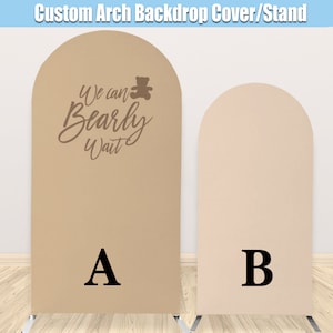 May include: Two arch backdrop covers, one beige with the text "We can Bearly Wait" and a teddy bear graphic, and one light beige. The covers are labeled A and B.