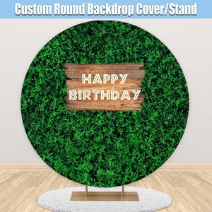 May include: A round green backdrop with a wooden sign that says "Happy Birthday".