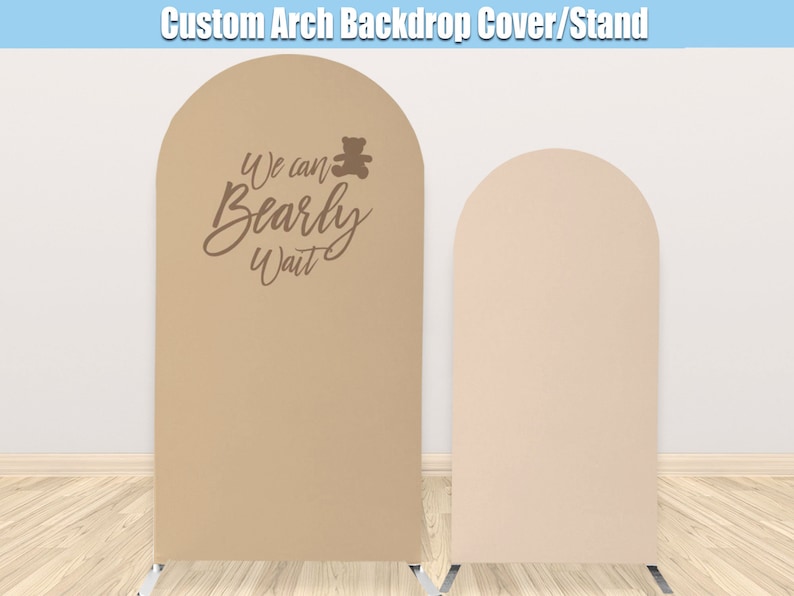 May include: Two arch backdrop covers for a baby shower. The backdrop on the left is tan with the text "We can Bearly Wait" and a small brown teddy bear. The backdrop on the right is a light pink.