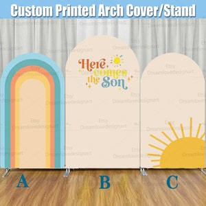 May include: Three different designs for a custom printed arch cover or stand. The first design features a rainbow arch with a peach, orange, and yellow colour scheme. The second design features a peach background with the text "Here comes the Son" in a retro font. The third design features a peach background with a yellow sun and rays.