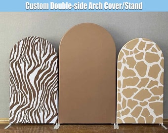 May include: Three arch covers for a backdrop or photo booth. The covers are made of fabric and have different patterns: zebra stripes, solid brown, and giraffe print. The covers are freestanding and have a rounded top.