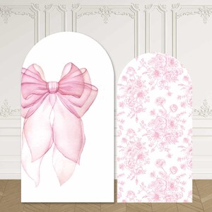 May include: Two arched display panels featuring pink designs. The left panel displays a large, translucent pink ribbon bow on a white background. The right panel features an all-over pattern of pink floral illustrations on a white background.