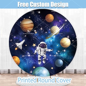 May include: A round printed backdrop featuring a blue and black space scene with stars, planets, a rocket ship, and an astronaut. The text "Free Custom Design" and "Printed Round Cover" are also included.