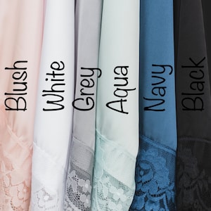 May include: Six different colors of fabric swatches with lace trim. The colors are blush, white, grey, aqua, navy, and black.