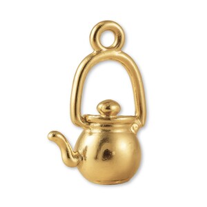 May include: A gold-colored charm in the shape of a teapot. The charm has a loop at the top for attaching to a chain or bracelet. The teapot has a spout, handle, and lid. The charm is likely made of metal.